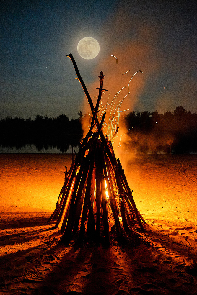 View bonfire on the background of the river and the moon by Bogdan Pigulyak