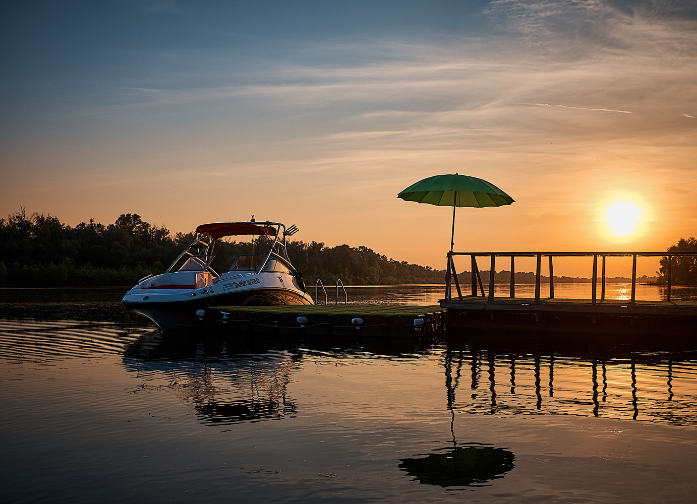 View Boat at the pier at sunset by Bogdan Pigulyak