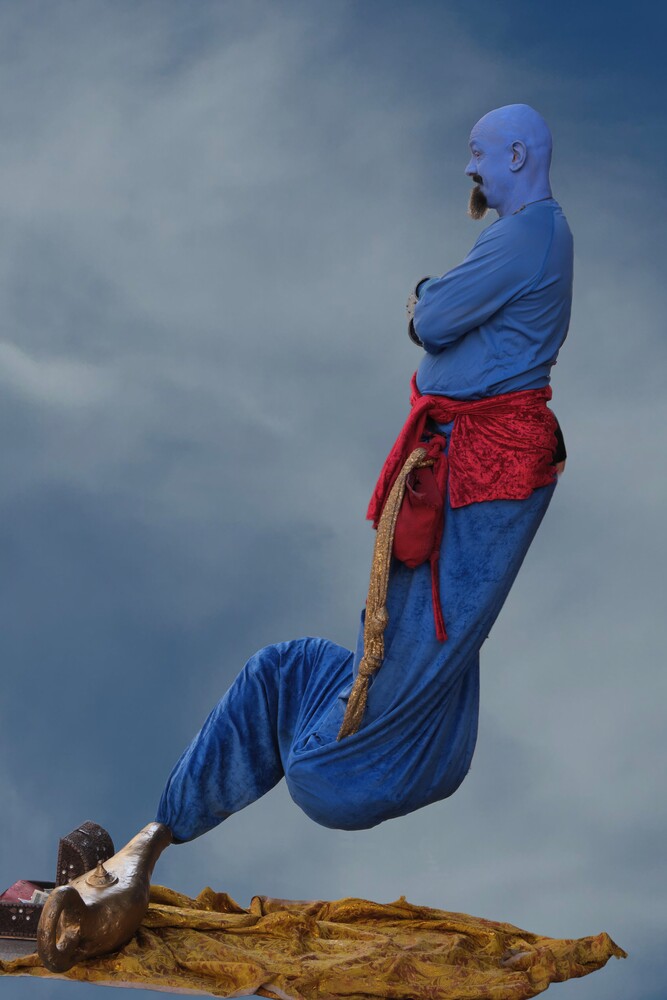 Person in blue and red superhero costume suspended mid-air against cloudy sky