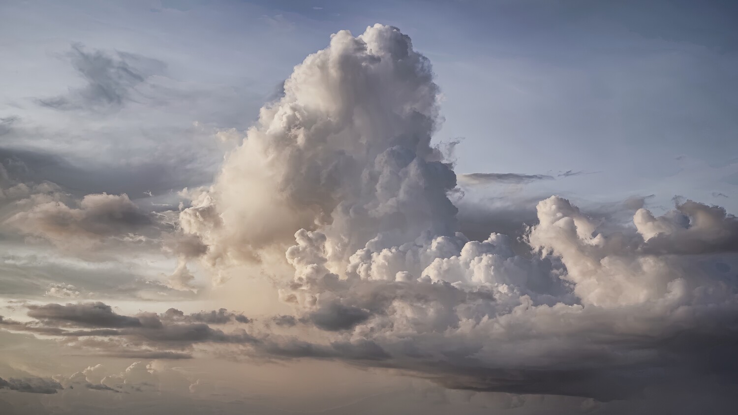 Towering cumulonimbus cloud formation against dramatic evening sky