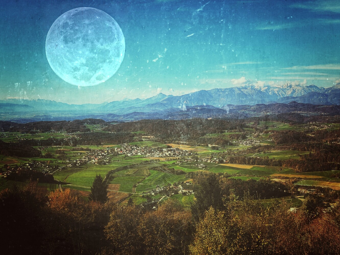 Luminous full moon suspended above alpine valley with snow-capped mountains and scattered settlements
