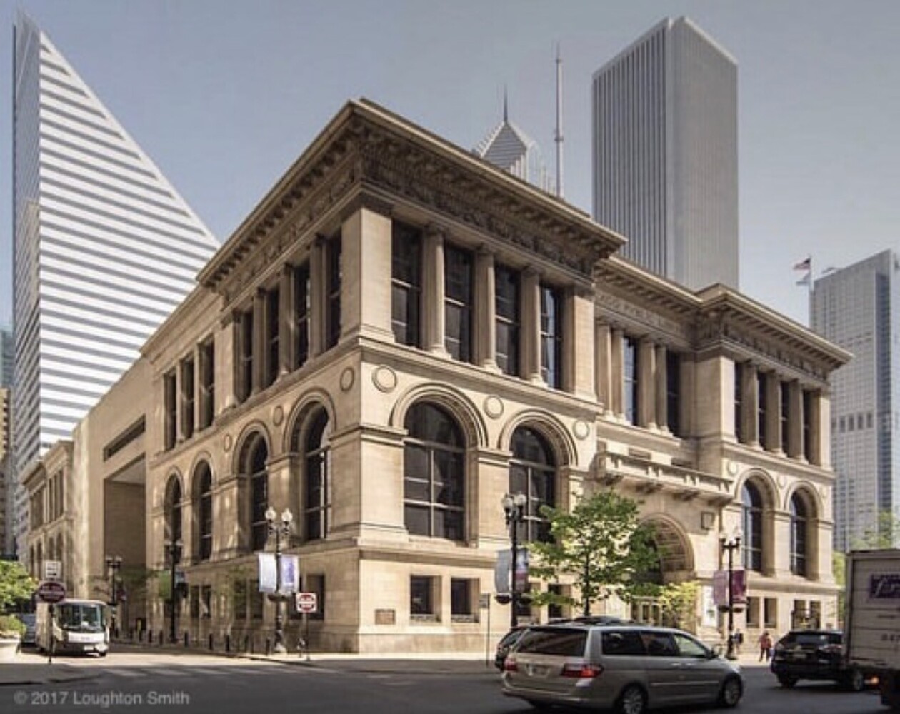 Neoclassical stone building with arched windows flanked by modern glass skyscrapers
