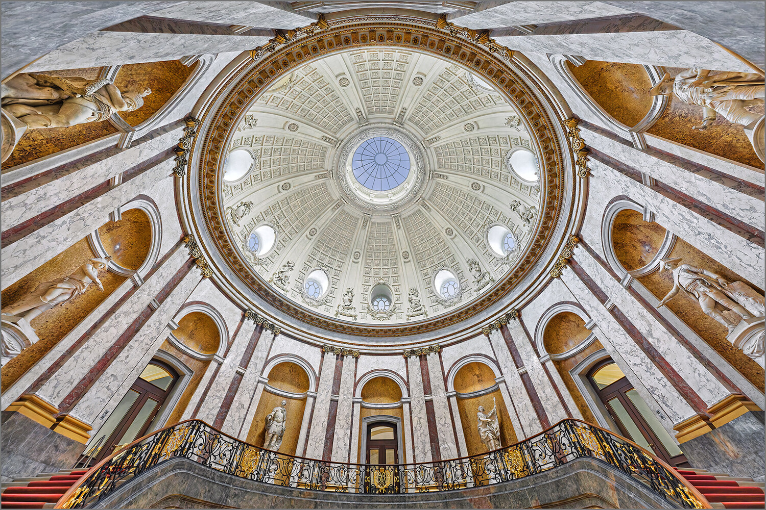 Symmetrical interior dome with ornate radiating ceiling and classical architecture
