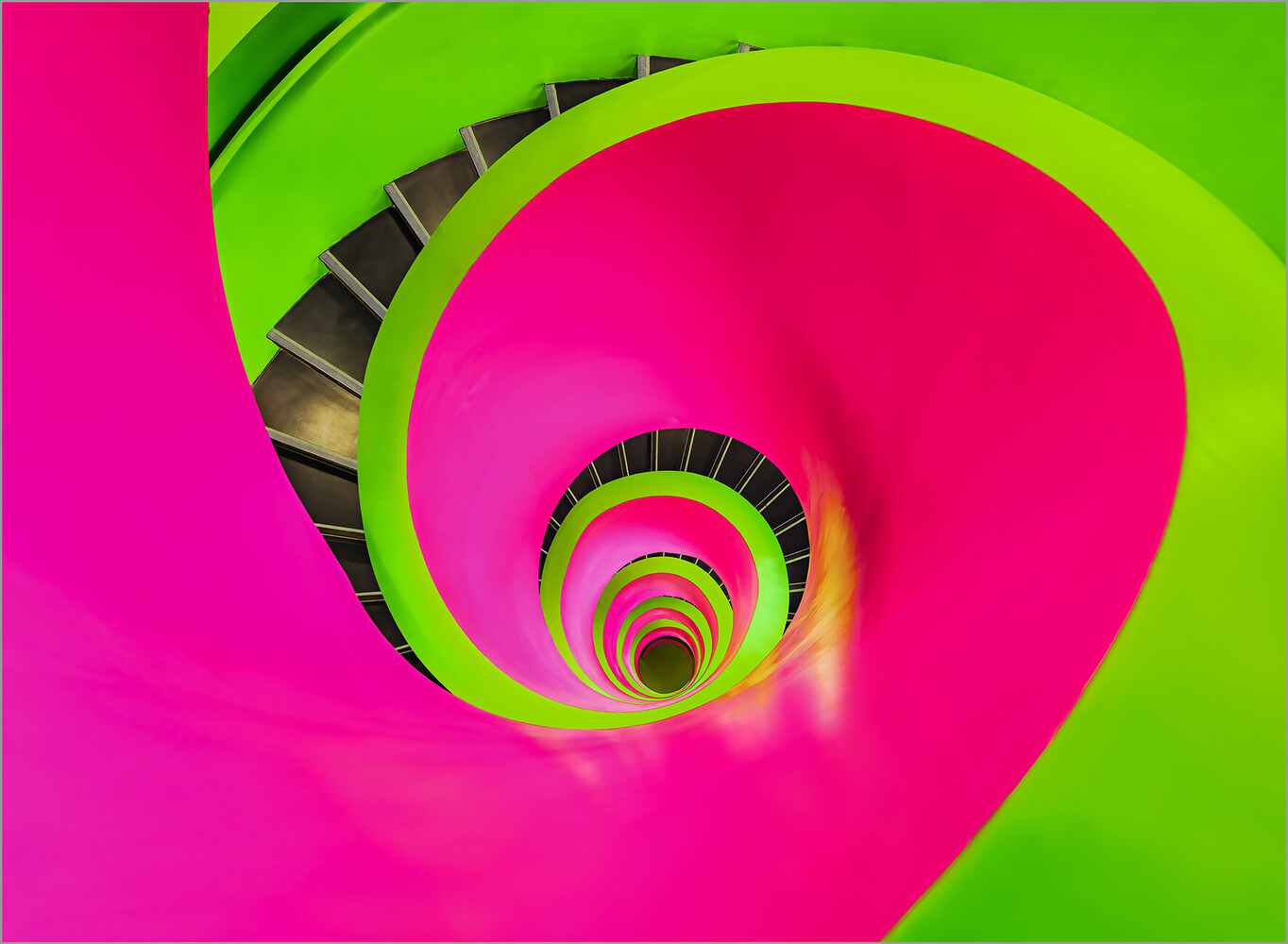 Vibrant spiral staircase with neon pink and lime green geometric architecture