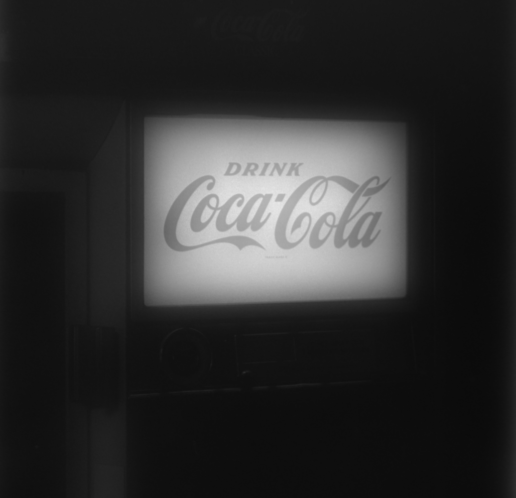 Vintage Coca-Cola neon sign glowing against dark background