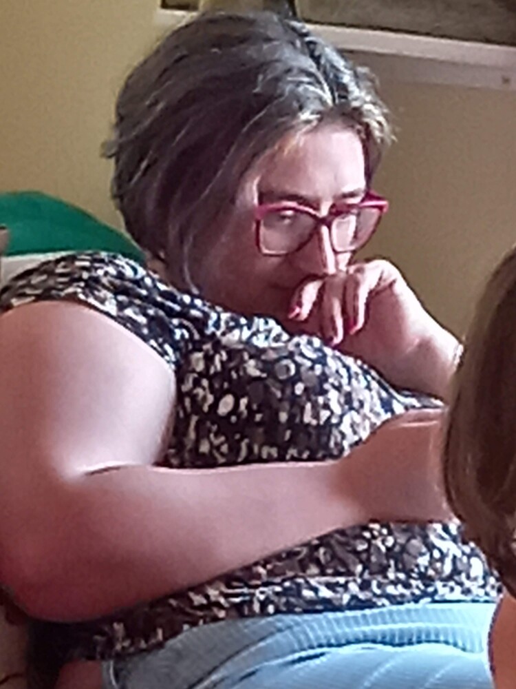 Person wearing glasses and sequined clothing in candid indoor moment