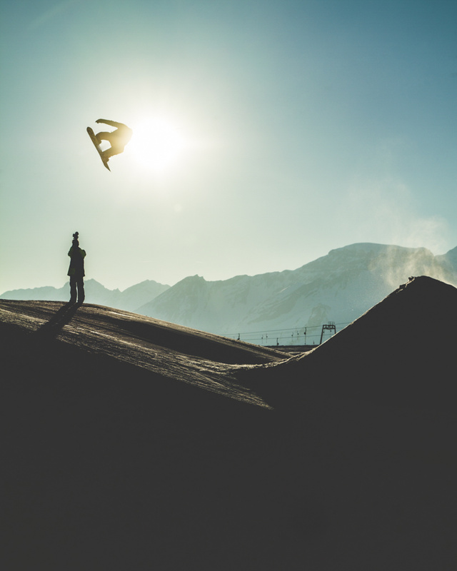 View Snowboarder accross the Crans-Montana sun by Anthony Brown