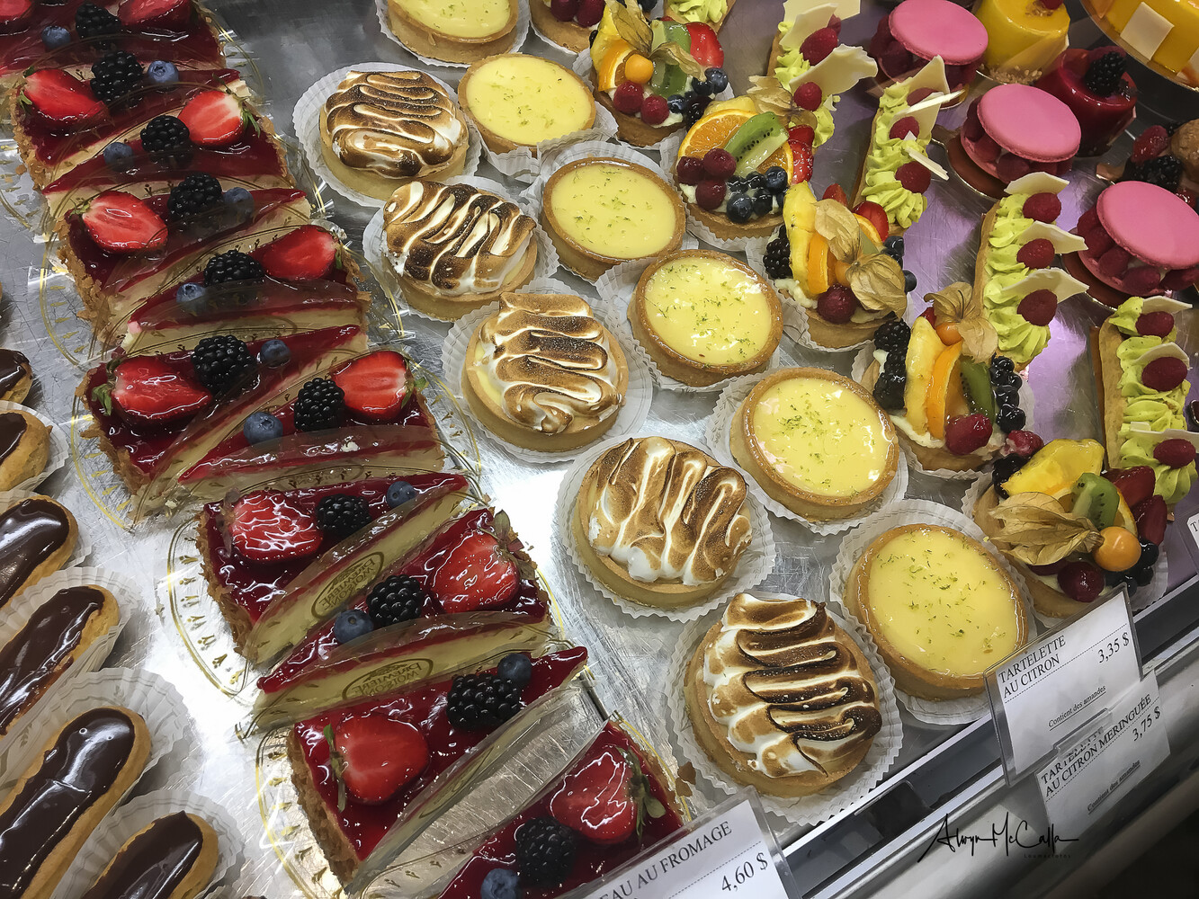 Overhead arrangement of artisanal pastries and desserts on clear display containers