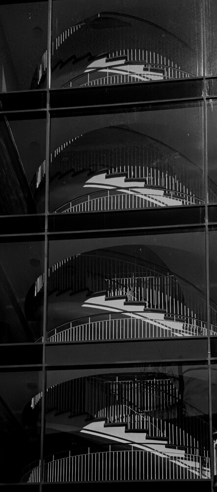 Four-frame black and white contact sheet showing repeated architectural detail of curved structural ribbing