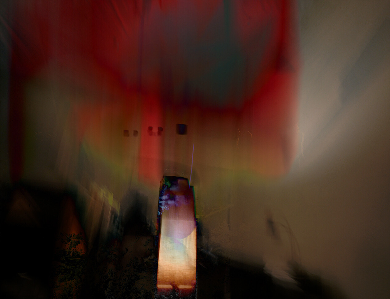 Blurred abstract composition with warm red and orange light emanating from center vertical element