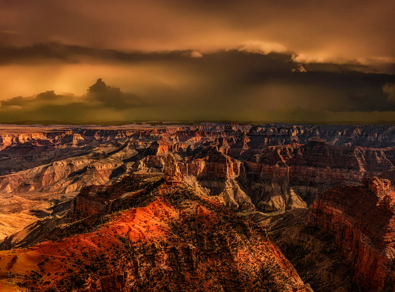 Grand Canyon landscape at sunset with dramatic golden light illuminating red rock formations under stormy sky