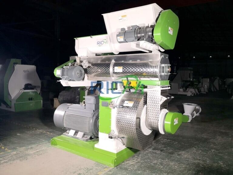 Green and white industrial pellet mill machine with electric motor and mechanical components