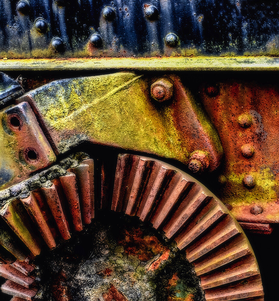 Rusted metal gears and machinery with moss and patina covered surfaces
