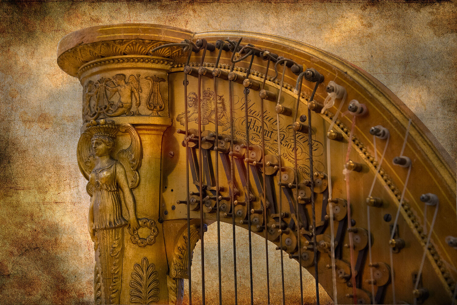 Close-up of a gilded harp's carved pillar featuring a winged female figure, with strings and tuning pins in warm, aged tones.