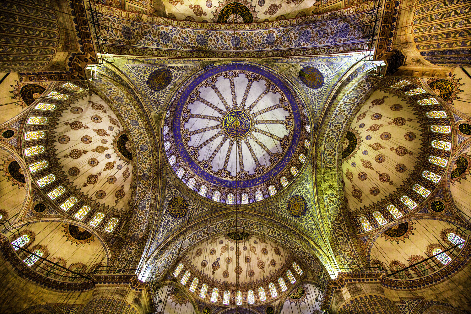 Ornate domed ceiling with radiating geometric patterns and central blue medallion