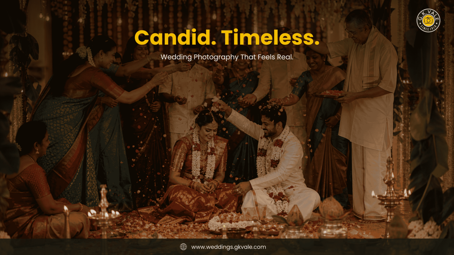 Indian wedding ceremony with bride and groom seated surrounded by family members in traditional attire
