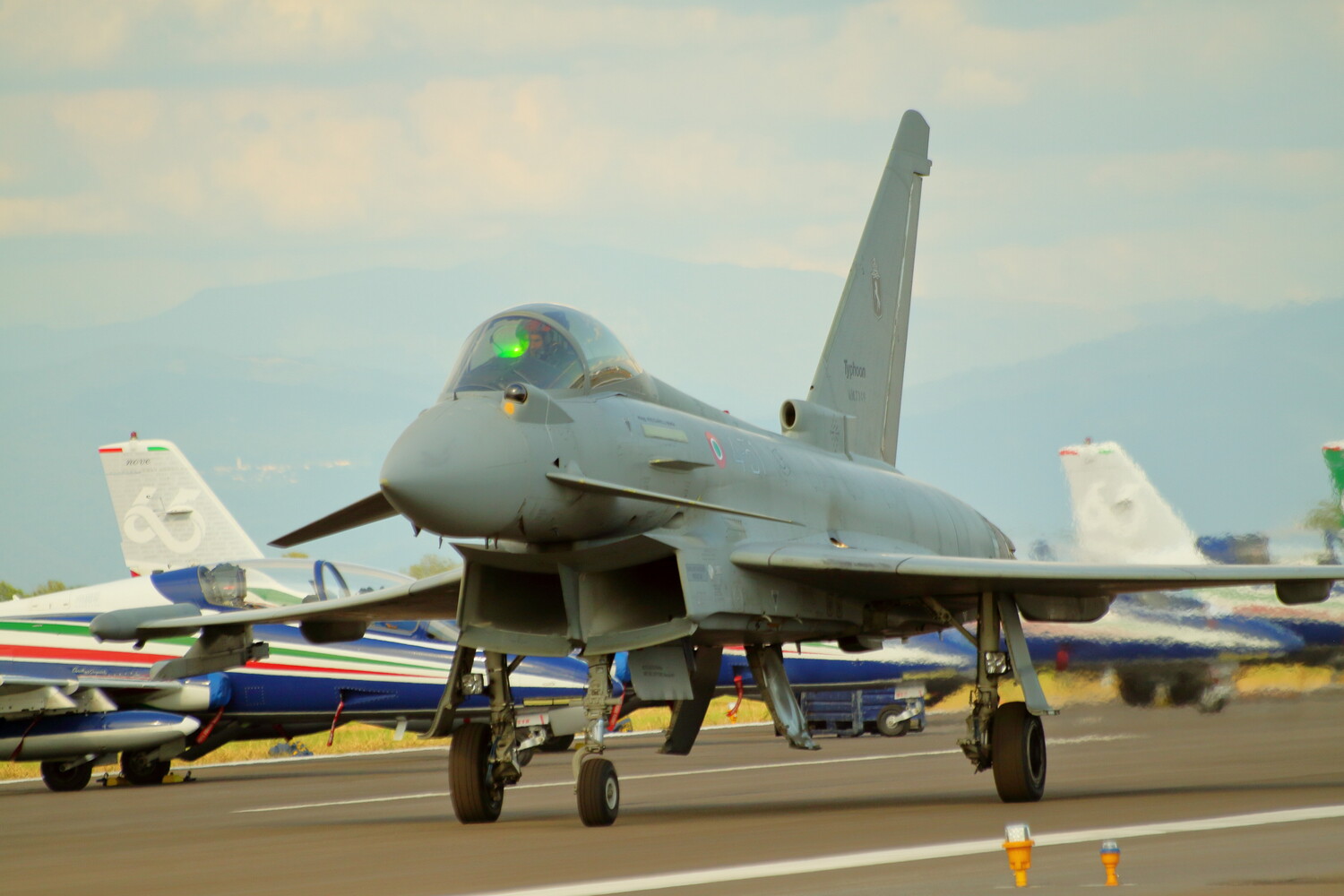 Eurofighter Typhoon fighter jet parked on airport tarmac with landing gear deployed