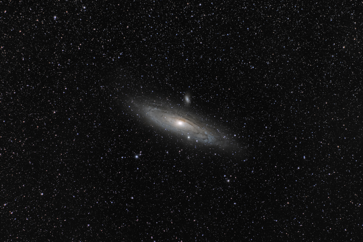 Andromeda Galaxy captured against a starfield with dark dust lanes visible across its disk