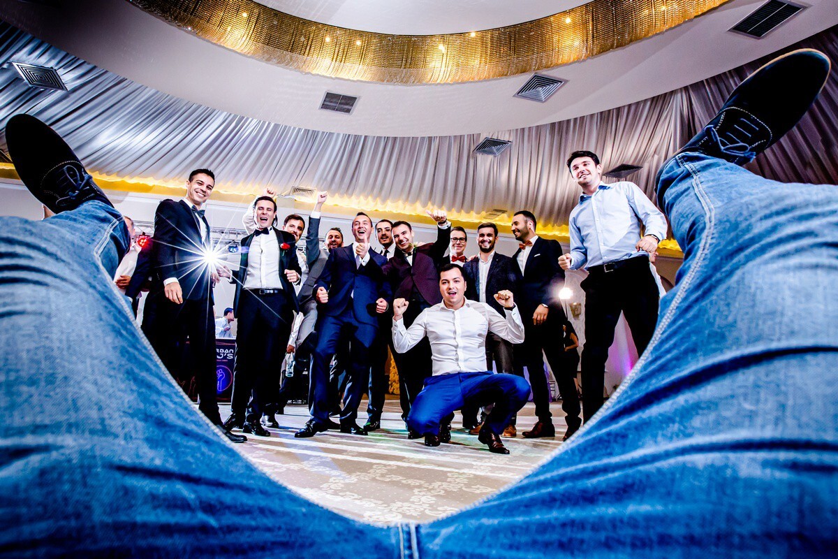 Group of professionals in business attire gathered in a circular formation indoors, shot from below