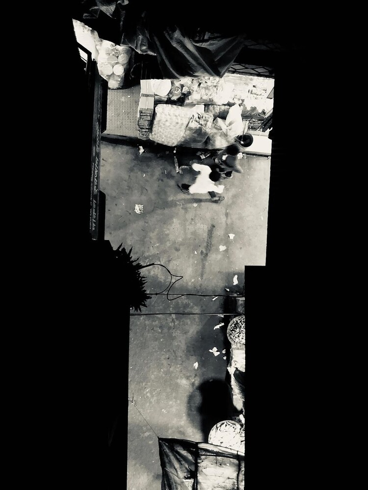 Aerial overhead view of urban street intersection with buildings and vehicles