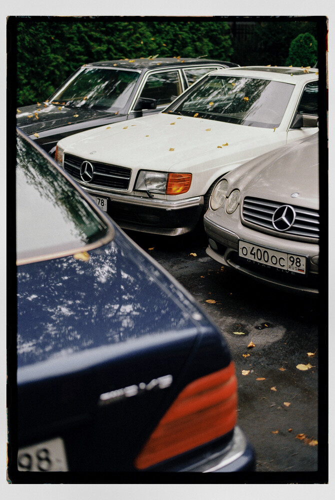 Three Mercedes-Benz sedans parked closely together, shot from a low angle perspective