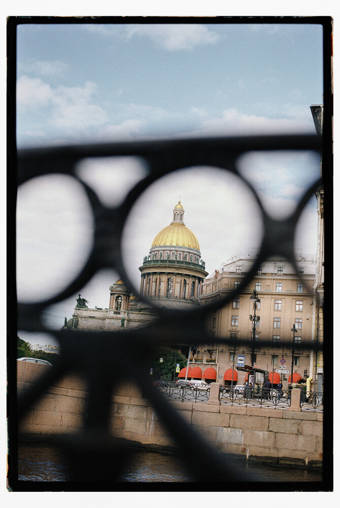 Saint Isaac's Cathedral dome framed through ornate metal railings