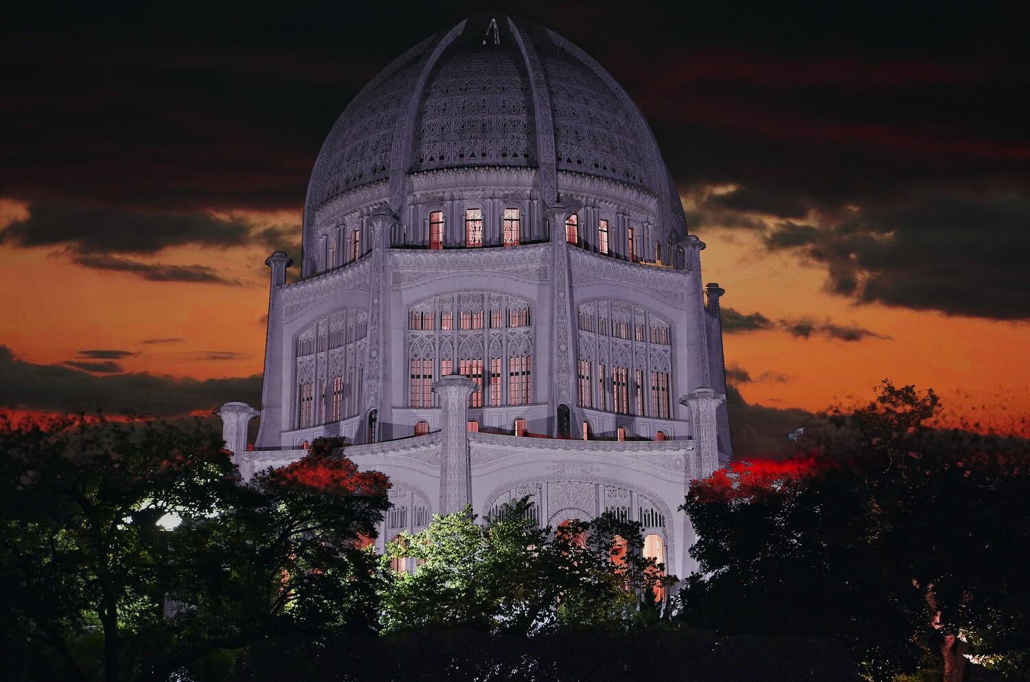 Illuminated white domed building at twilight with dramatic orange and dark sky