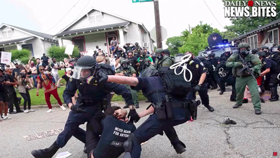 Watch Photo of woman confronting Lousiana police goes viral on YouTube.