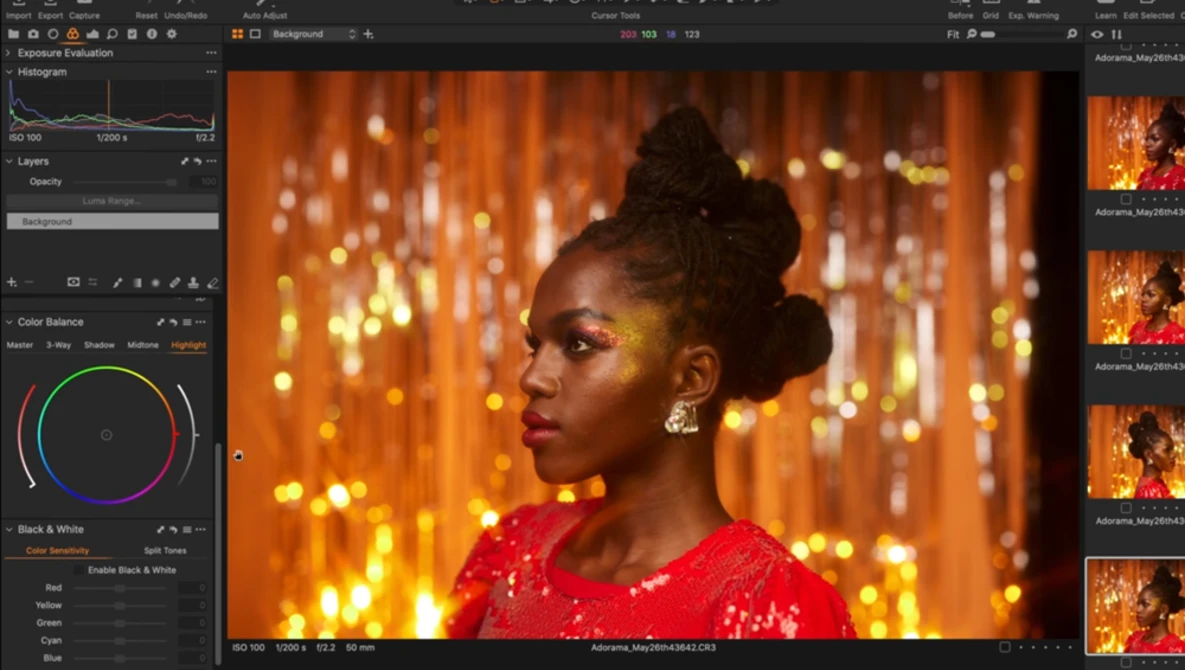 Woman in red sequined dress against warm golden bokeh background, photographed in profile with studio lighting.
