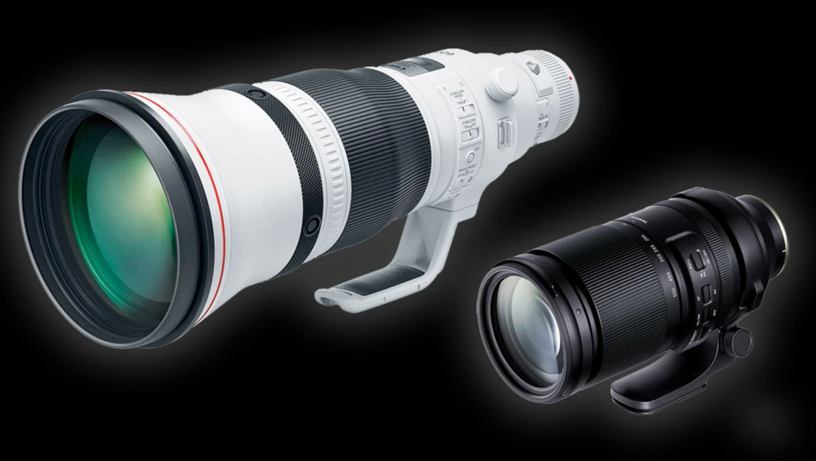 White telephoto lens and black telephoto lens displayed side-by-side against a dark background.