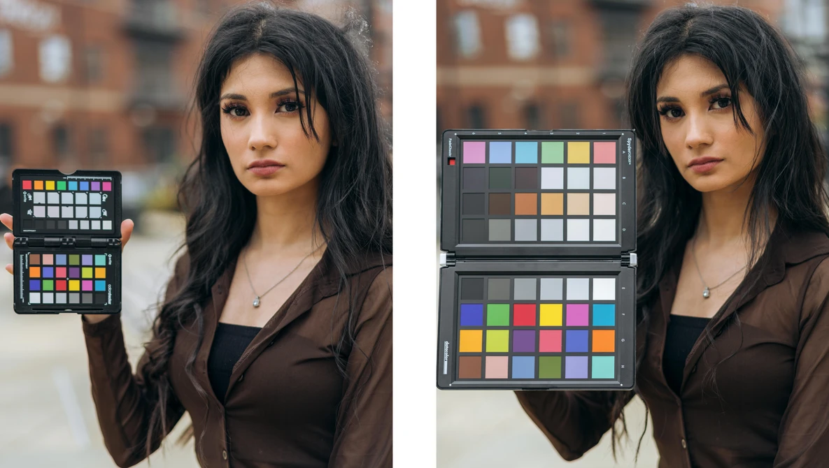Photographer holding color reference charts during outdoor portrait shoot with brick building backdrop.