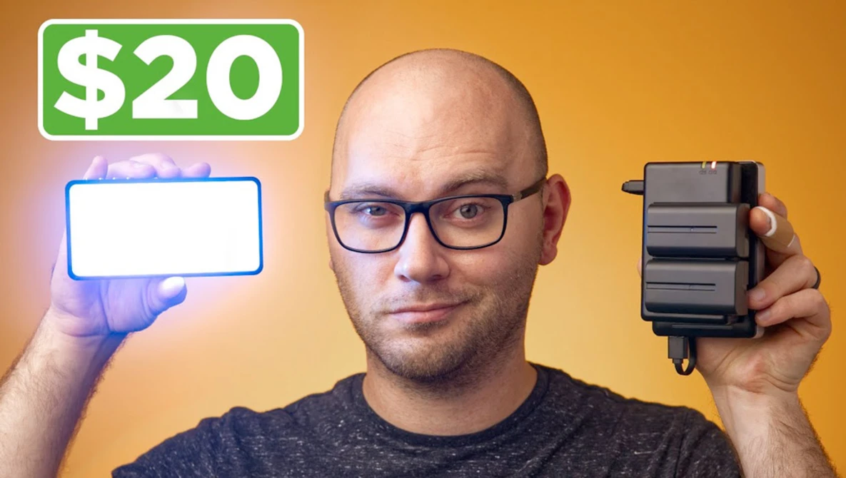 Man holding a blank neon-style sign and battery pack against a golden yellow background.