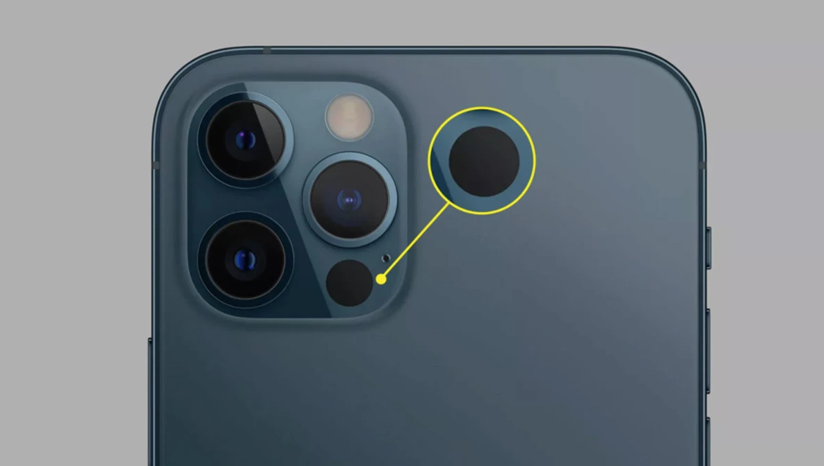 Close-up of a smartphone camera module with multiple lenses highlighted against a gray background.