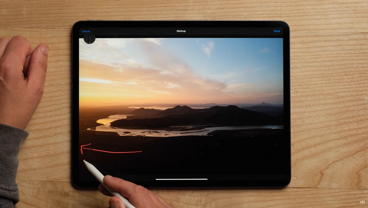 Screenshot of photo editing interface displaying a sunset landscape with golden sky reflecting on water.