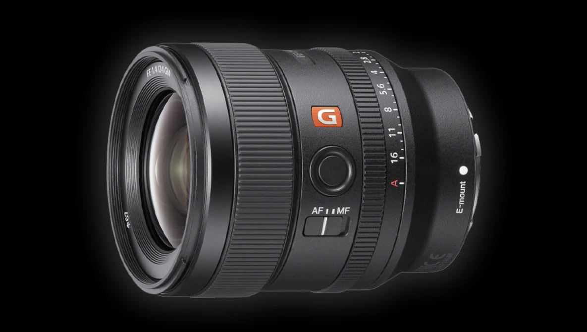 Sony FE 24mm f/1.4 GM prime lens with autofocus ring and aperture scale visible against dark background.