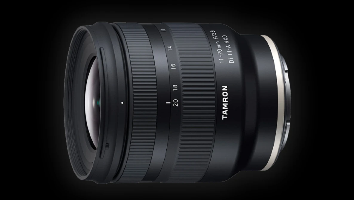 Tamron 11-20mm ultra-wide zoom lens with focus ring and aperture markings visible against dark background.