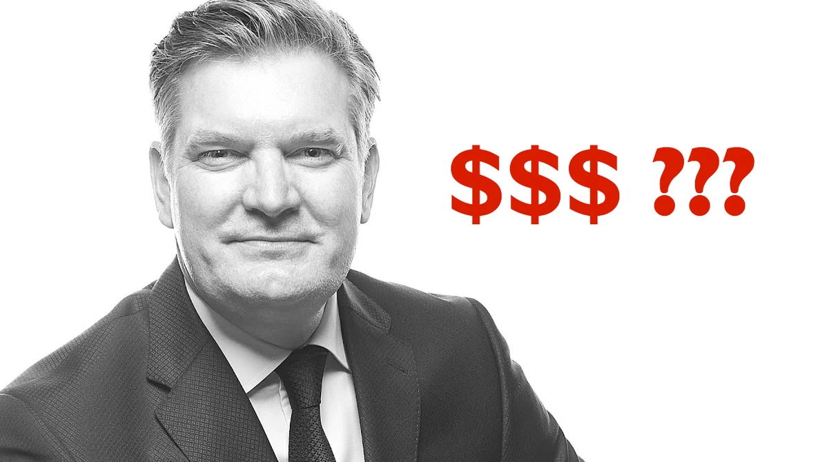 Professional headshot of a man in business attire with dollar signs and question marks overlaid in red text.