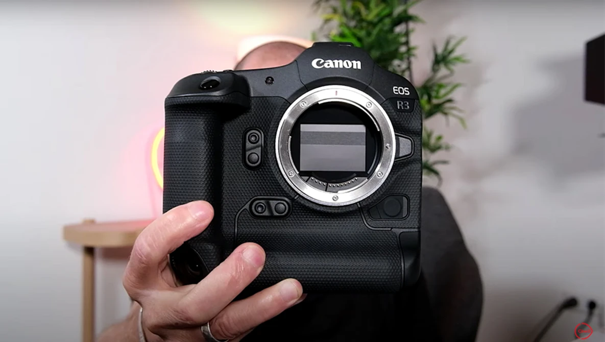 Canon EOS R5 mirrorless camera held up to display the sensor and mirror box.