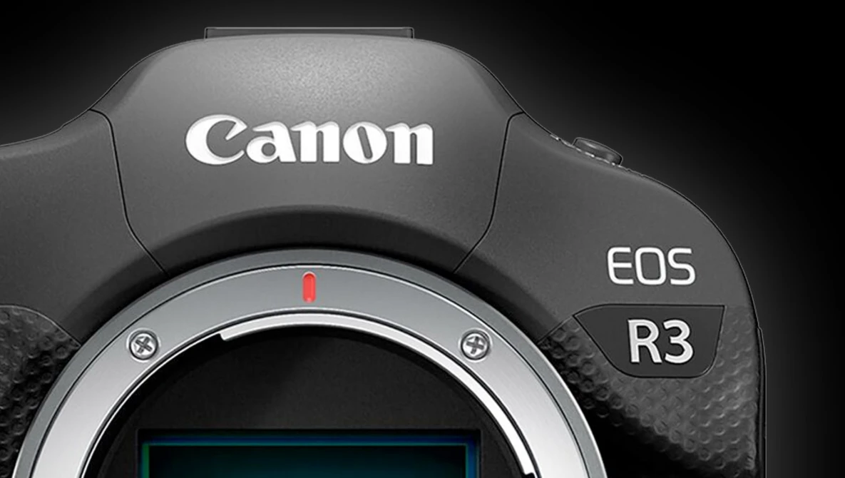 Canon EOS R3 mirrorless camera body viewed from above, showing the lens mount and top surface with branding.
