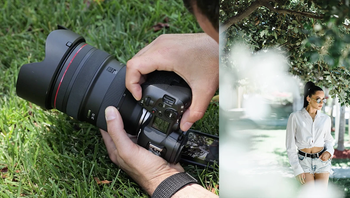 Photographer holding a mirrorless camera with wide-angle lens over grass, with portrait of woman in bright, overexposed outdoor setting displayed on right.