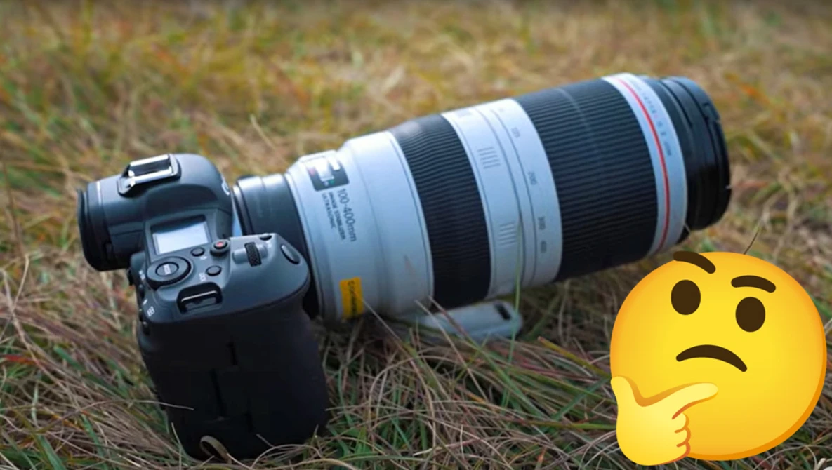 DSLR camera with telephoto zoom lens mounted on grass, alongside a confused emoji symbol.
