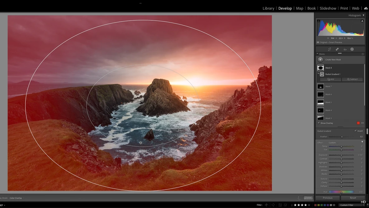 Screenshot of photo editing software showing a coastal landscape with warm red color grading and an oval crop overlay.