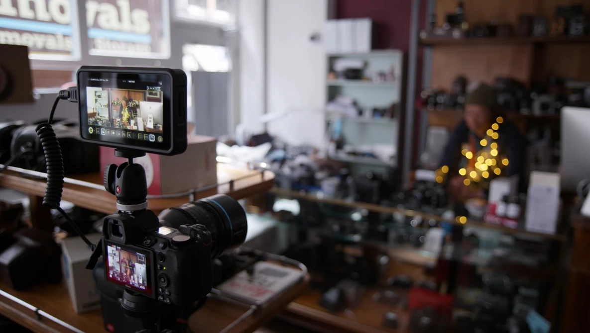 Professional camera rig with external monitors mounted on a workbench in a production studio.