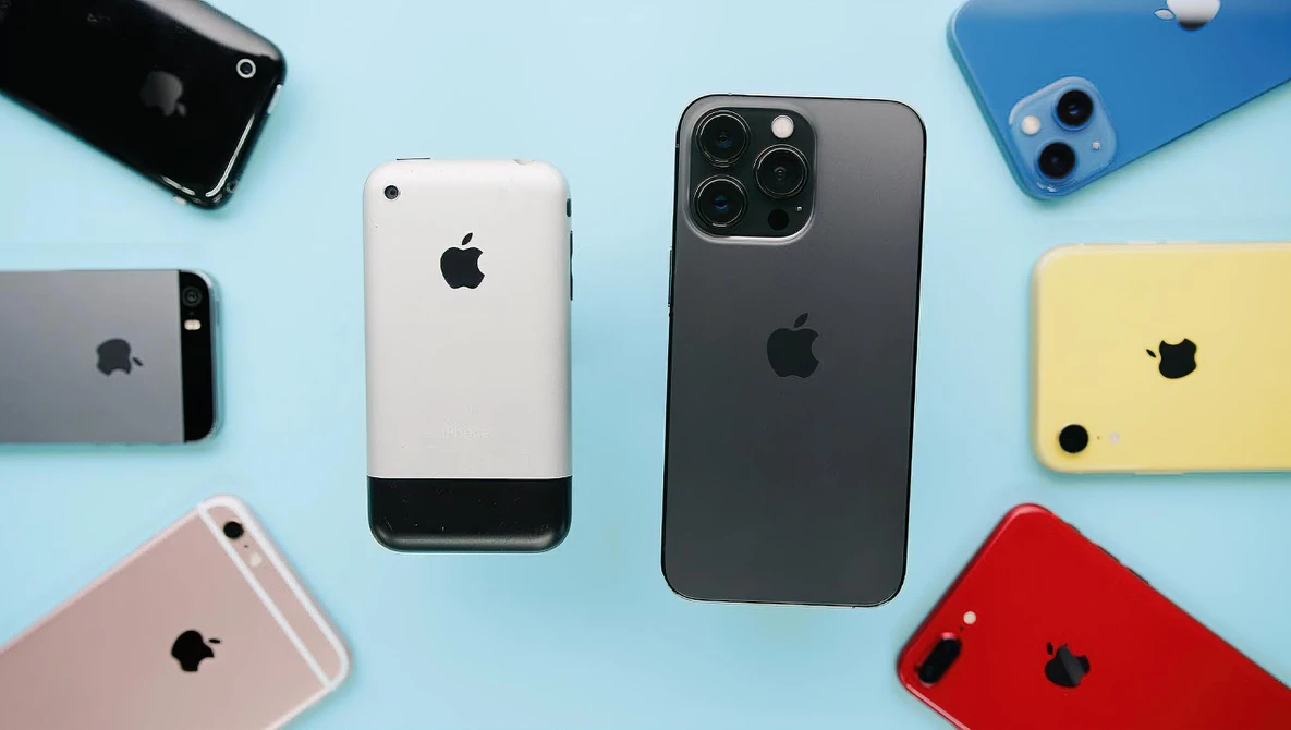 Collection of iPhones in various colors and generations arranged on a light blue background.