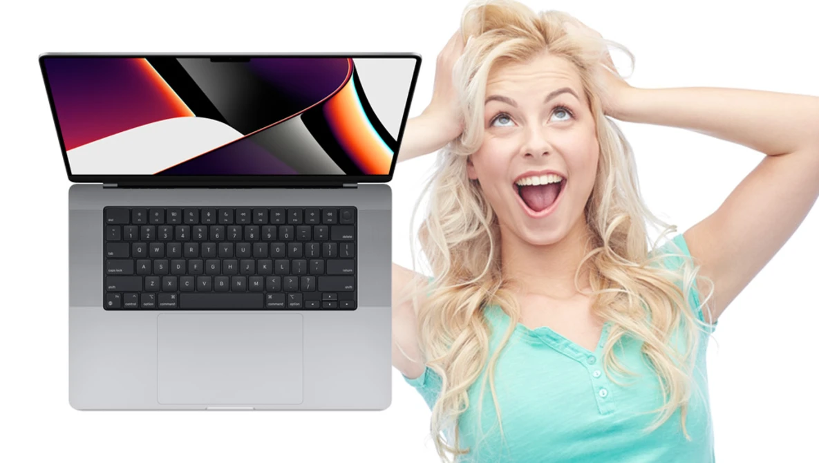 Laptop displaying colorful abstract wallpaper next to excited woman in turquoise top.