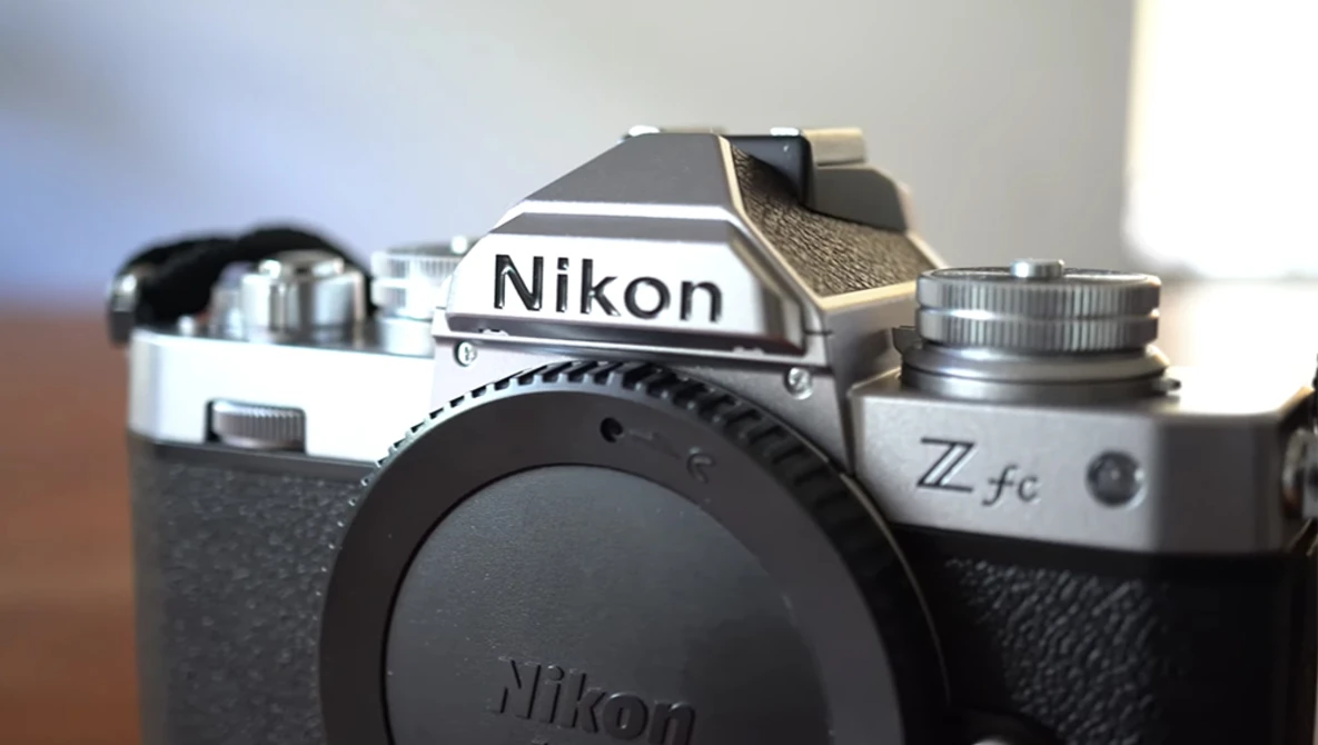 Nikon Z fc mirrorless camera body shown from above at an angle, displaying the top plate and lens mount with no lens attached.