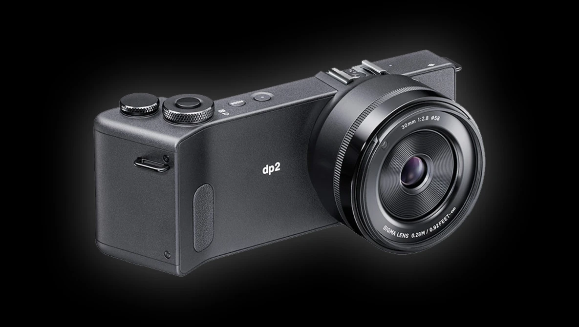 The Sigma dp2 compact digital camera with fixed lens mounted on black background.