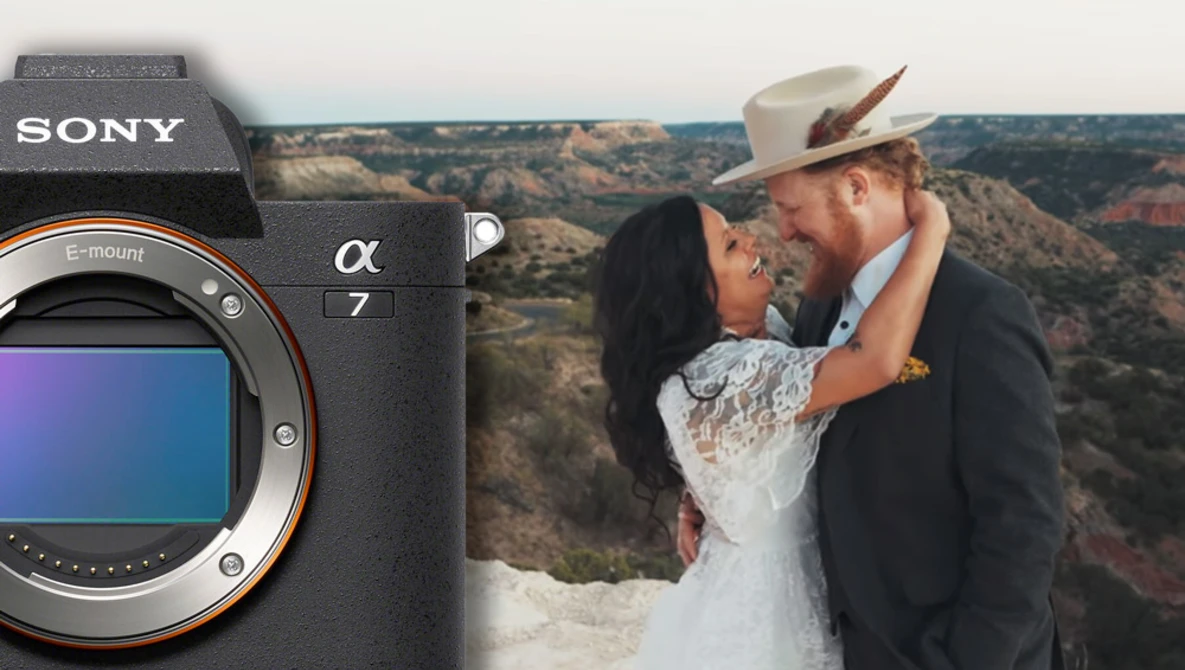 Sony Alpha 7 camera body next to couple embracing at canyon overlook.