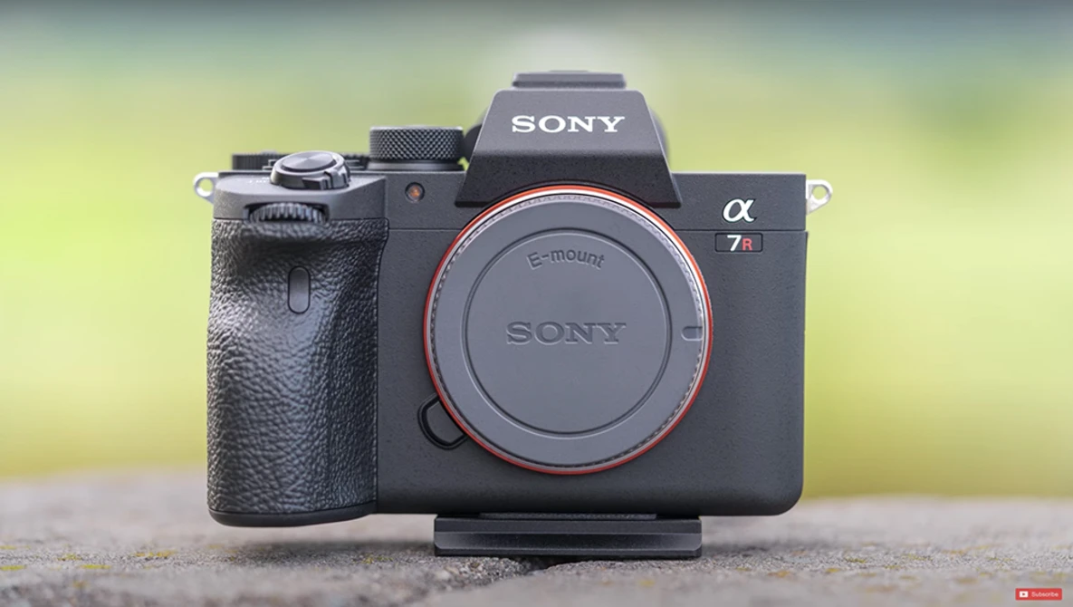 Sony α7 II mirrorless camera body with E-mount displayed against a blurred yellow-green background.