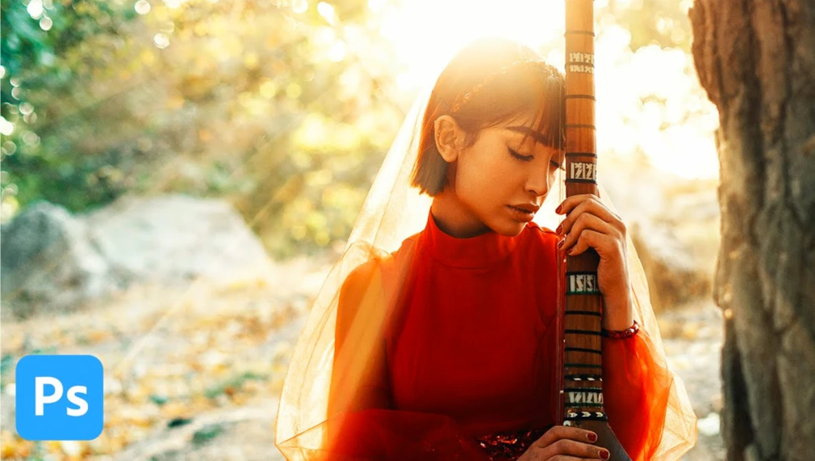 Woman in red clothing holding a traditional stringed instrument against a tree, backlit by golden sunlight.